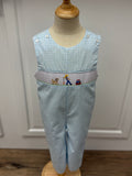 This Boys Gone Fishing Longall showcases a charming blue and white gingham pattern, highlighted by a detailed smocked fisherman &amp; his best friend embroidery on the front. Designed for comfort and style, it pairs perfectly with a classic Peter Pan collar shirt, creating an adorable and polished outfit ideal for playful days and special occasions.