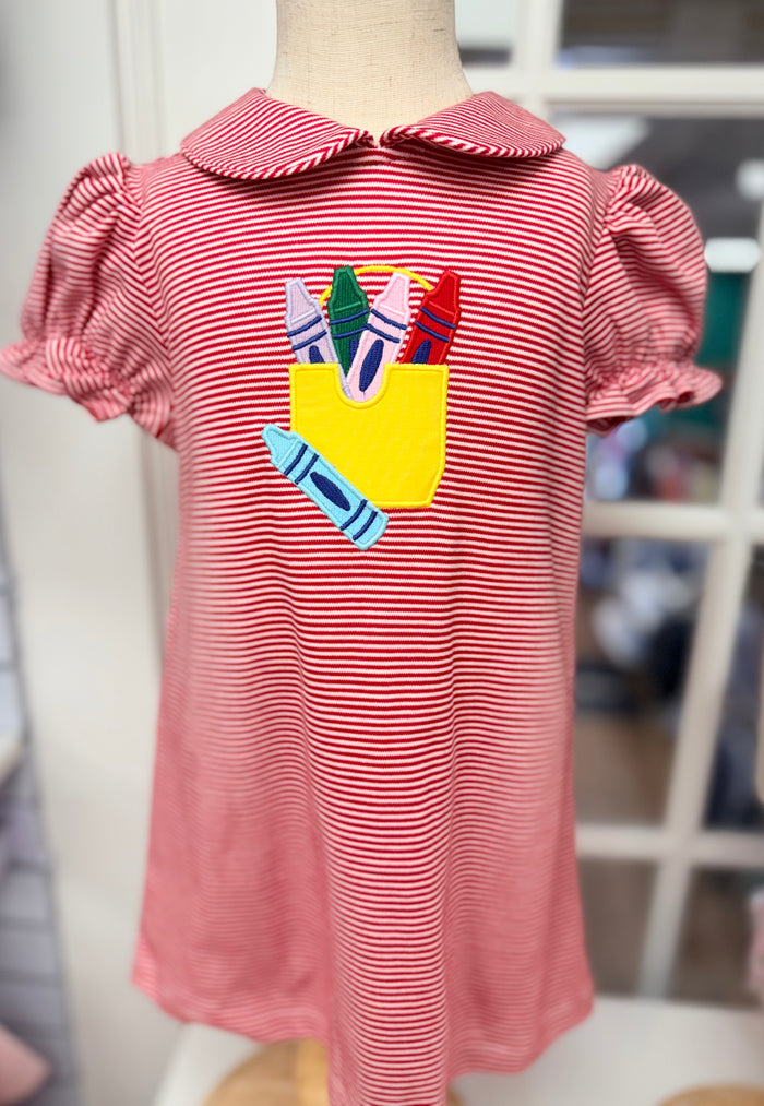 Ready to brighten her first day of school? The Crayon Box Dress by Cape Point Clothing Co. bursts with playful charm—vivid red stripes, a colorful crayon box appliqué, and a sweet Peter Pan collar make this dress an unforgettable statement of joy and creativity!