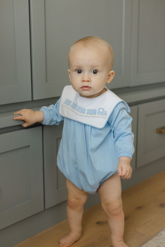 Dress your little one in Bailey Boys’ All Aboard Knit Infant Bubble and watch imaginations take flight! Soft, light blue knit wraps your baby in cozy comfort, while charming train embroidery sparks adventure from the very first wear. Ready for cuddles and journeys alike!