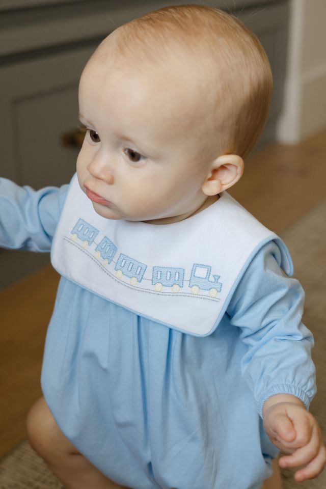Dress your little one in Bailey Boys’ All Aboard Knit Infant Bubble and watch imaginations take flight! Soft, light blue knit wraps your baby in cozy comfort, while charming train embroidery sparks adventure from the very first wear. Ready for cuddles and journeys alike!