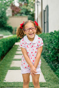 Dress your little one in the enchanting Apple Blossoms Bloomer Set by The Proper Peony. This delightful ensemble features charming apple and bow prints, complemented by a soft white Peter Pan collar. Crafted from luxurious Pima cotton, it offers unmatched comfort—perfect for those memorable first school days!
