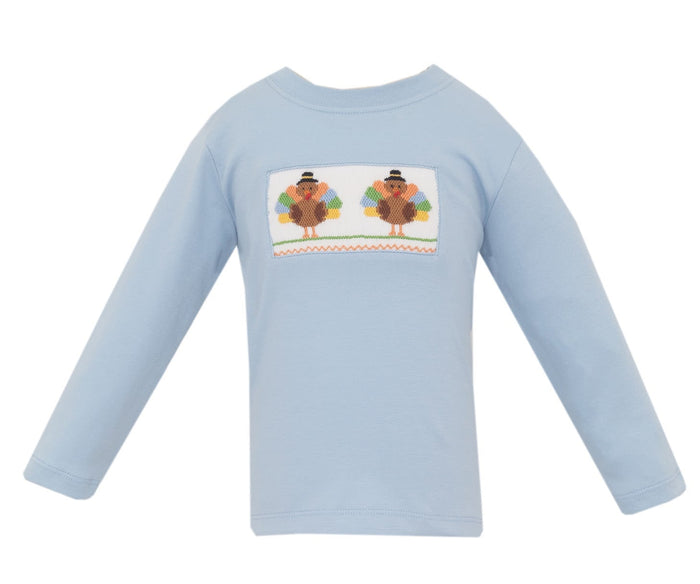 The Blue Knit Turkey Smocked Tee by Anavini brings festive charm to your little one’s Thanksgiving with soft, breathable fabric and delicate turkey smocking. This light blue tee blends comfort and tradition, making every moment cozy and memorable. Celebrate with warmth and style!