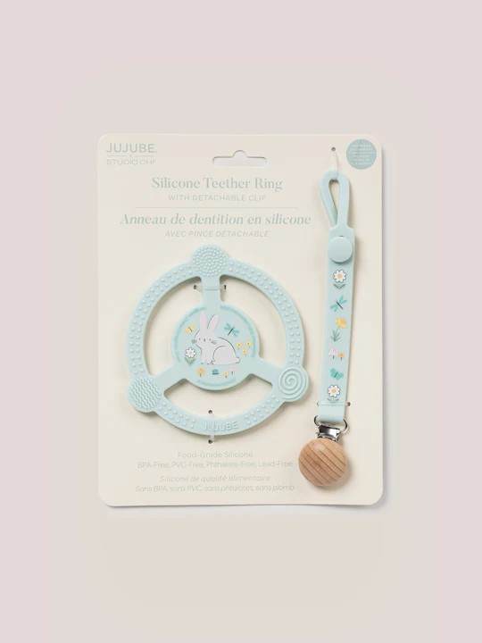 Help soothe your baby’s sore gums with the Silicone Teether Ring with Detachable Clip from JuJuBe x Studio Oh! This teether features an easy-to-grip design and three different massaging textures so Baby can choose what feels best. Place it in the freezer before use for additional cooling relief. This nontoxic, food-grade silicone teether is dishwasher-safe, and most importantly, it is BPA-free, PVC-free, phthalate-free, and lead-free, making it safe to go in Baby’s mouth. A snug-closing clip and silicone lo
