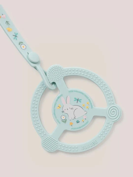 Help soothe your baby’s sore gums with the Silicone Teether Ring with Detachable Clip from JuJuBe x Studio Oh! This teether features an easy-to-grip design and three different massaging textures so Baby can choose what feels best. Place it in the freezer before use for additional cooling relief. This nontoxic, food-grade silicone teether is dishwasher-safe, and most importantly, it is BPA-free, PVC-free, phthalate-free, and lead-free, making it safe to go in Baby’s mouth. A snug-closing clip and silicone lo