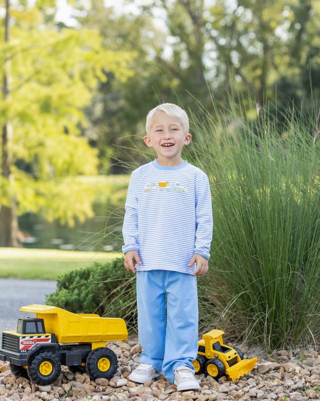 Fuel your little builder’s imagination with the Construction Trucks Pant Set by Trotter Street Kids. The cozy light blue striped top, decorated with lively construction truck appliqués, pairs perfectly with blue pants—ideal for adventurous toddlers ready to explore autumn days in style and comfort!