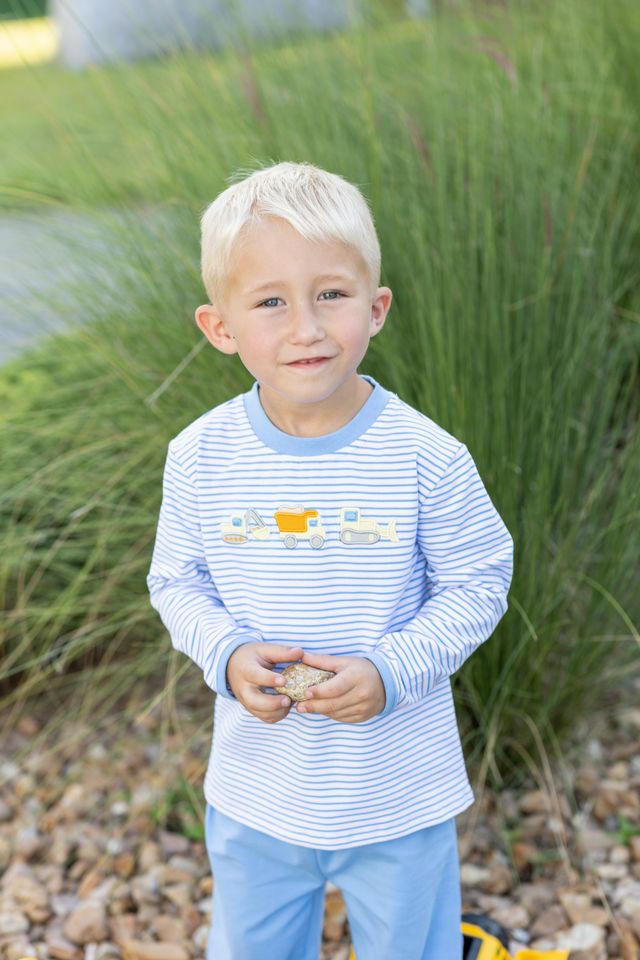 Fuel your little builder’s imagination with the Construction Trucks Pant Set by Trotter Street Kids. The cozy light blue striped top, decorated with lively construction truck appliqués, pairs perfectly with blue pants—ideal for adventurous toddlers ready to explore autumn days in style and comfort!