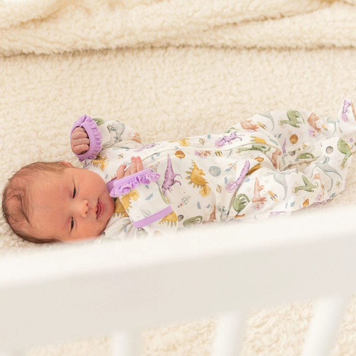 Blast off to bedtime with the Luna &amp; Arlo Cosmic Dinos Zip Footie in Wisteria. Crafted from sumptuous Pima Cotton, this cozy footie wraps your little dreamer in cloud-soft comfort. Featuring an enchanting all-over print of adorable dinosaurs sporting space helmets, it sparks imagination even at rest. Wisteria accents on the trims and zipper bring a delightful pop of color that makes bedtime feel like an adventure. The convenient front zip makes diaper changes and bedtime routines effortless.