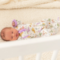 Blast off to bedtime with the Luna &amp; Arlo Cosmic Dinos Zip Footie in Wisteria. Crafted from sumptuous Pima Cotton, this cozy footie wraps your little dreamer in cloud-soft comfort. Featuring an enchanting all-over print of adorable dinosaurs sporting space helmets, it sparks imagination even at rest. Wisteria accents on the trims and zipper bring a delightful pop of color that makes bedtime feel like an adventure. The convenient front zip makes diaper changes and bedtime routines effortless.