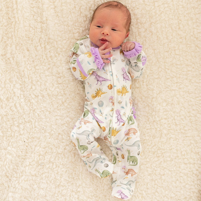 Blast off to bedtime with the Luna &amp; Arlo Cosmic Dinos Zip Footie in Wisteria. Crafted from sumptuous Pima Cotton, this cozy footie wraps your little dreamer in cloud-soft comfort. Featuring an enchanting all-over print of adorable dinosaurs sporting space helmets, it sparks imagination even at rest. Wisteria accents on the trims and zipper bring a delightful pop of color that makes bedtime feel like an adventure. The convenient front zip makes diaper changes and bedtime routines effortless.