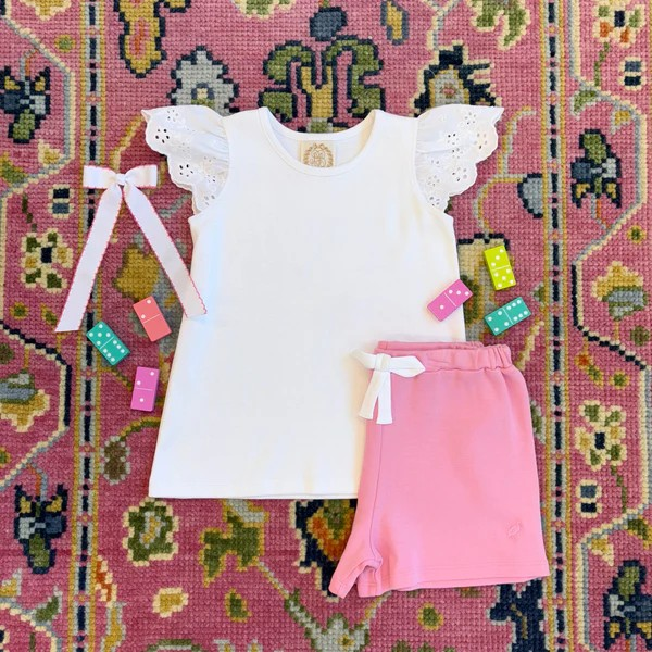 Elevate her wardrobe with Ellen's Eyelet White Knit Top by The Beaufort Bonnet Company. The darling eyelet flutter short sleeves add a touch of charm to this classic design, making it a versatile closet staple for spring and summer. A must-have for every little fashionista!