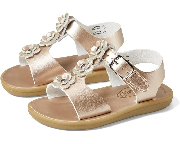 The Footmates Jasmine Sandals are a perfect combination of style and convenience. Made with leather and eco-friendly microfiber nappa uppers, they feature three double-flower appliques for a charming touch. The modern hook and loop straps, with false buckles, not only give the sandals a classic look but also make it easy for your child to put them on and take them off independently.