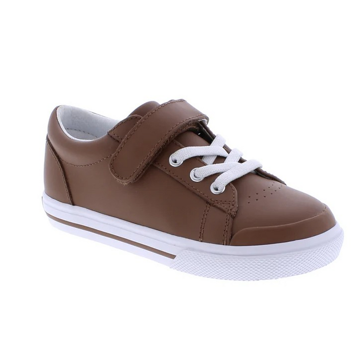 Footmates Reese Brown Leather Sneaker- Leather blucher oxford vulcanized sneaker featuring hook-and-loop closure and decorative elasticized false-laces.
Custom Fit System – Removable,&nbsp;dual&nbsp;insoles in Medium and Wide provided for customized fitting.
Roomy Toe Box – Allows tiny toes room to breathe and splay naturally during walking, enhancing balance and reducing rubbing, friction, and moisture.
Arch Support – Shoe last and insole designed to provide proper arch support for developing feet.
Firm He