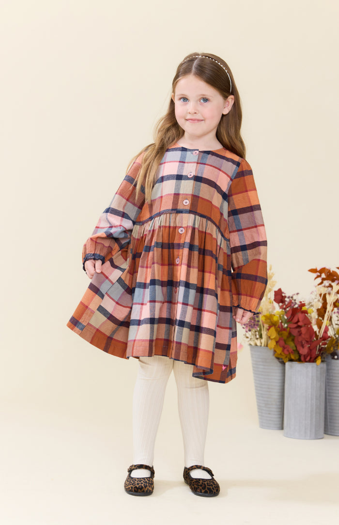 Celebrate autumn in vibrant style with the Girls Mae Dress - Hayride Plaid by Pink Chicken. Its warm orange plaid and button-down design bring cozy charm and effortless comfort, making it the perfect choice for spirited tweens ready to embrace the season with confidence!