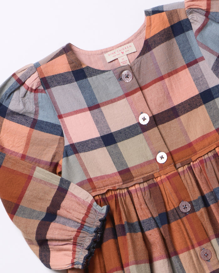 Celebrate autumn in vibrant style with the Girls Mae Dress - Hayride Plaid by Pink Chicken. Its warm orange plaid and button-down design bring cozy charm and effortless comfort, making it the perfect choice for spirited tweens ready to embrace the season with confidence!
