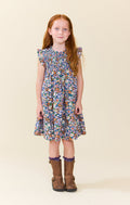 Pink Chicken’s Girls Stevie Dress in True Blue Sketched Floral bursts with vibrant colors and lively florals, making every moment feel joyful and bright. Perfect for tween girls who love playful, spirited style that stands out effortlessly.