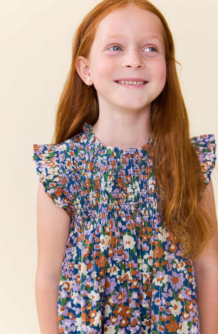 Pink Chicken’s Girls Stevie Dress in True Blue Sketched Floral bursts with vibrant colors and lively florals, making every moment feel joyful and bright. Perfect for tween girls who love playful, spirited style that stands out effortlessly.