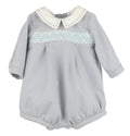 Crafted for timeless charm, this Infant Boys Dusty Blue Smocked Bubble features a classic Peter Pan collar with delicate embroidered borders. The front showcases hand-smocked embroidery, adding a refined touch perfect for special occasions or memorable photo milestones.