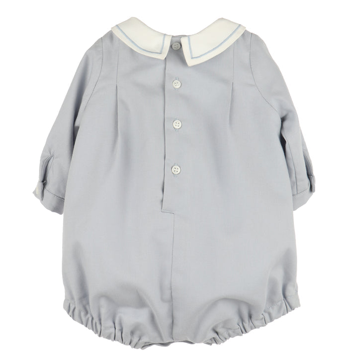 Crafted for timeless charm, this Infant Boys Dusty Blue Smocked Bubble features a classic Peter Pan collar with delicate embroidered borders. The front showcases hand-smocked embroidery, adding a refined touch perfect for special occasions or memorable photo milestones.