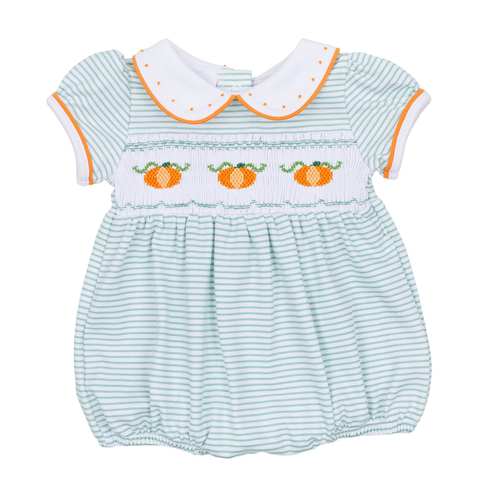Dress your little one in cozy fall charm with the Lil' Pumpkin Classics Smocked Short Sleeve Girl Bubble in Celery by Magnolia Baby. This adorable infant bubble features delicate smocking, embroidered pumpkin accents, and a timeless collar that blends classic style with comfortable wear. Perfect for autumn days, it’s an easy way to keep your baby looking sweet and seasonally dressed.