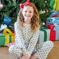 Dress your little one in holiday cheer with the Millie Girls' Lounge Pant Set from Lila &amp; Hayes. Crafted from soft, breathable pima cotton, this long-sleeved top and pant set features a charming Christmas Tree print that’s perfect for festive mornings. Delicate white piping around the neckline adds a touch of refinement, while the elastic waistband ensures a comfortable fit all day long. Ideal for cozy winter days, this set combines playful style with all-day comfort for your joyful holiday moments.