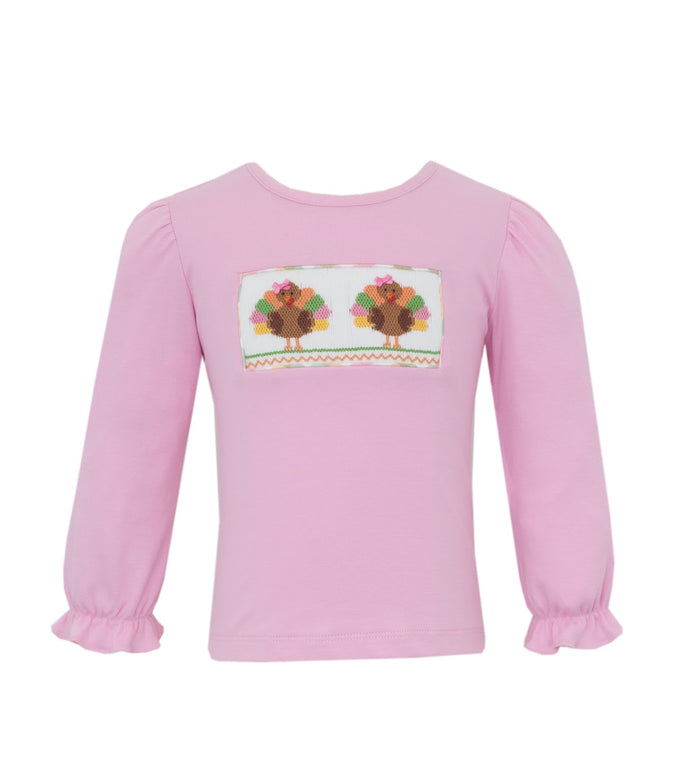 The Pink Knit Smocked Turkey Tee by Anavini brings warmth and charm to your toddler’s Thanksgiving outfit. Its soft pink knit fabric feels gentle on the skin, while the delicate turkey smocking captures the festive spirit with playful elegance. Celebrate the season in cozy style!