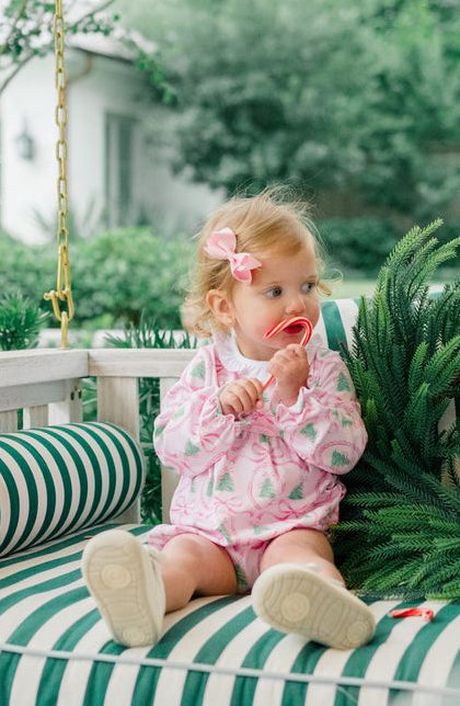 The Pink Tannenbaum Bubble by The Proper Peony delights with its soft pink Christmas pine print and crisp white ruffled collar, dressing your little girl in festive charm and timeless sweetness this holiday season.