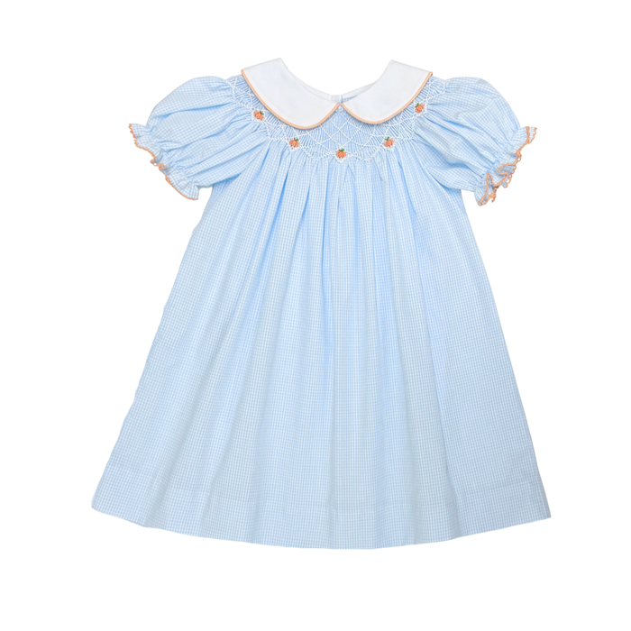The Pumpkin Billie Bishop Dress by Zuccini Kids delights with its light blue gingham, charming pumpkin smocking, and crisp white Peter Pan collar. Orange piping adds a pop of playful color, making this dress a joyful celebration of fall for your toddler girl.
