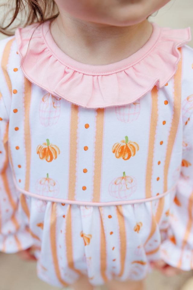 Celebrate fall’s magic with the Pumpkin Patch Ruffle Bubble by Trotter Street Kids! This charming infant romper wraps your little one in soft pink and orange pumpkins, finished with a sweet ruffled collar—perfect for cozy autumn days and unforgettable seasonal moments. Ready for all the fall fun!