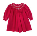 Petit Ami’s Red Smocked Bishop Dress captivates with delicate red and white dots, charming smocking adorned with flowers and hearts, and a timeless design that brightens Christmas and Valentine’s Day alike. Includes matching bloomers for a complete, adorable look.