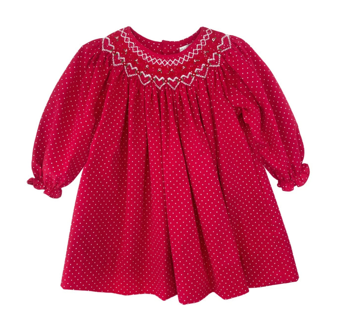 Petit Ami’s Red Smocked Bishop Dress captivates with delicate red and white dots, charming smocking adorned with flowers and hearts, and a timeless design that brightens Christmas and Valentine’s Day alike. Includes matching bloomers for a complete, adorable look.