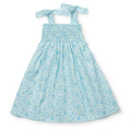 Get ready for some fun in the sun with the Sandcastles Blue Betsy Dress from Lila &amp; Hayes! This toddler dress features a vibrant ocean blue color with a playful sand castle design and comfortable smocked bodice. The tie straps add an extra touch of cuteness. Available in sizes 2t-6, this dress is perfect for a beach vacation.