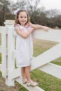 Indulge in the beauty of nature with Thea Flower Bouquet Dress from James &amp; Lottie! Adorned with floral bouquets and cute bows, this dress exudes a sense of elegance. The pink and white seersucker ties on the shoulders add a charming touch. Perfect for any occasion, this dress will make you feel like a blooming flower!