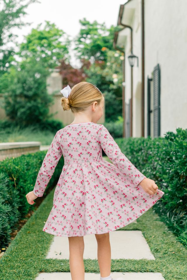 The Proper Peony’s Zinnia Blooms Twirl Dress delights with vibrant floral prints on soft Pima cotton, offering cozy comfort and twirl-worthy style for toddler girls. Perfect for winter holidays, it brings joy and charm to every special moment with effortless grace.